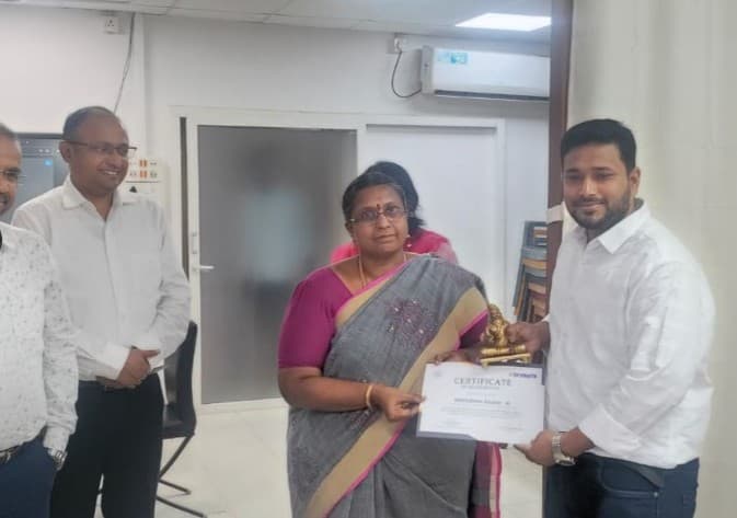 Award ceremony photo presenting the certificate of recognition